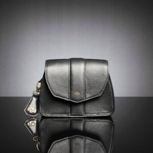 Close-up of the women's Belle side bag in premium black leather, featuring a sleek silhouette and durable metal fittings.