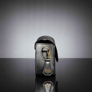 A refined black leather handbag with reinforced stitching and a timeless design for women in formal and casual settings.