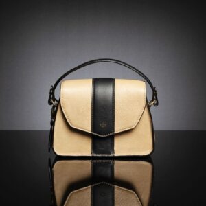 Women's Belle genuine leather side bag in tan, featuring a structured handle for a classic forearm carry style.