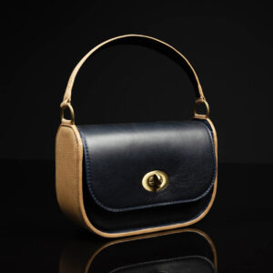 Women's luxury leather purse with a two-tone navy and tan design, featuring a structured body and premium craftsmanship.