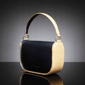 Side back view of the Luminara navy and tan leather handbag, showing the structured body and smooth leather surface.
