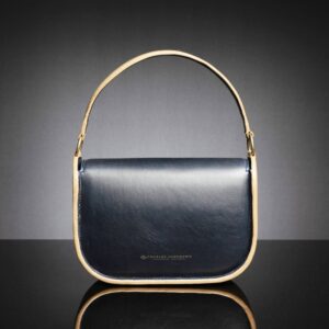 Luminara navy and tan leather handbag, back view, showcasing its structured silhouette and smooth premium leather finish.