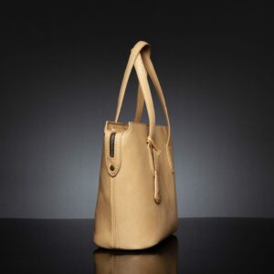 Angled view of the tan women's leather tote bag showcasing its reinforced handles and secure zip closure.