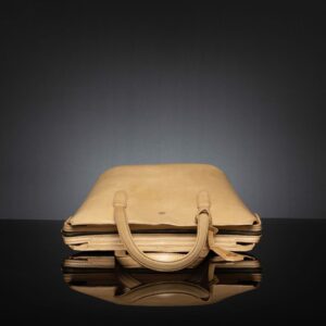 Flat-lay of the tan leather tote bag showing its spacious compartment and soft full-grain leather texture.