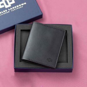 Women's black leather Gizelle bifold purse, displayed in a premium Charles Lansdown gift box, featuring a stylish compact design with multiple storage compartments.