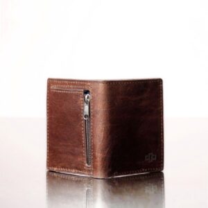 Close-up of the back of a rich brown leather mini purse, featuring a back zip compartment where coins can be stored.