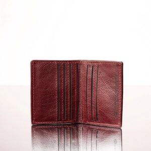 Elegant ruby red leather mini purse, featuring a refined bifold design with multiple storage compartments.