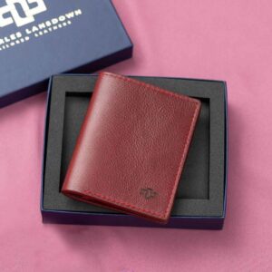 Women's ruby red leather Gizelle bifold purse, featured in a premium Charles Lansdown gift box, combining sophistication with secure storage for cards, notes, and coins.