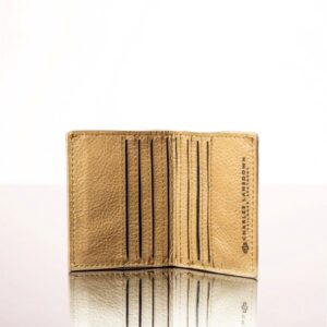 Inside view of a tan leather mini purse, showcasing multiple card slots and a secure compartment for notes and coins.