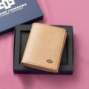 Women's tan leather Gizelle trifold purse, displayed in a premium gift box, designed with a secure trifold closure and refined leather craftsmanship.