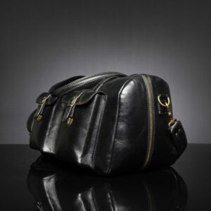 Side view of Marcella Overnight Duffle Bag in black leather, showcasing a full-length zipper for effortless packing.