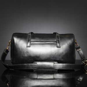 Back view of Marcella Overnight Duffle Bag in black leather, featuring a luggage sleeve for easy travel.