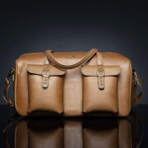 Marcella Overnight Duffle Bag in tan full-grain leather, showcasing a classic design with premium craftsmanship.