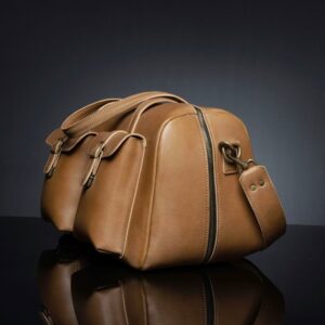 Side view of Marcella Overnight Duffle Bag in tan leather, featuring a deep-opening zipper for easy access.