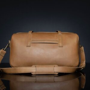 Back view of Marcella Overnight Duffle Bag in tan leather, featuring a luggage sleeve for easy travel.