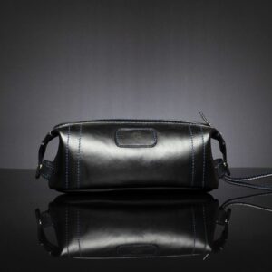 Mansfield Toiletry Bag in black full-grain leather, featuring a water-resistant inner and a sleek and structured design.