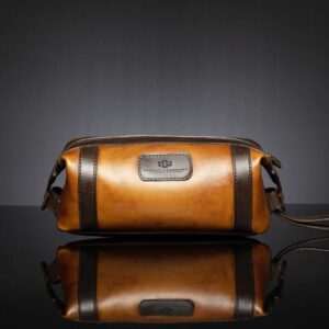 Mansfield Toiletry Bag in two-tone brown and tan leather, featuring a classic travel-ready design.