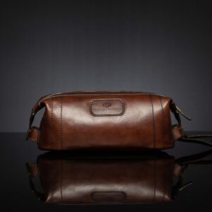 Mansfield Toiletry Bag in polished brown leather, featuring a refined, elegant finish.