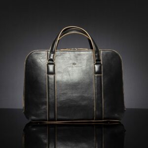 Reagan Euro black leather laptop bag with beige pinstripe, featuring a structured silhouette and modern design.