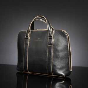 Side view of Reagan Euro black leather laptop bag, showcasing sturdy leather handles and a zip that extends low.