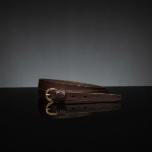 Elegant brown leather skinny belt, 20mm wide, styled for formal and casual outfits.