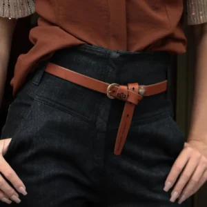 Slim 20mm rich tan leather belt, worn as a waist belt over dresses for an elegant touch.