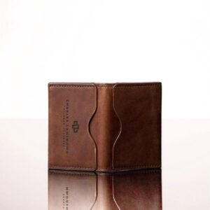 Handmade brown leather cardholder with compact bifold design, showcasing fine stitching and natural leather texture.