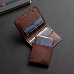 Mansfield bifold wallet in rich brown leather shown open with visible cards, highlighting its storage features.