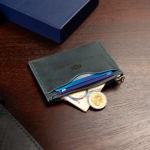 Men’s blue leather zipped cardholder with a compact design. Features curved slots and a secure zip for extra storage.