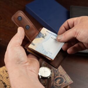 Close-up of the Belvoir Streamline Moneyclip Cardholder in rich brown leather, emphasizing the strong magnetic clip for cash security.