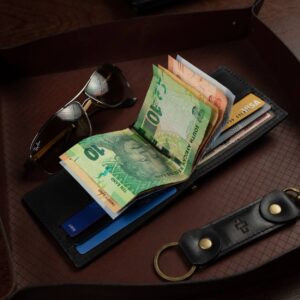 Benjamin black bifold wallet with brass money clip displayed open with notes and cards, highlighting its functionality.